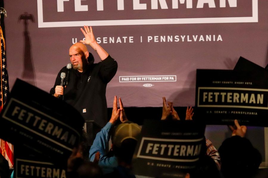 Democratic senate candidate John Fetterman waves to supporters at a rally at Carpenters Union Hall Monday night.
