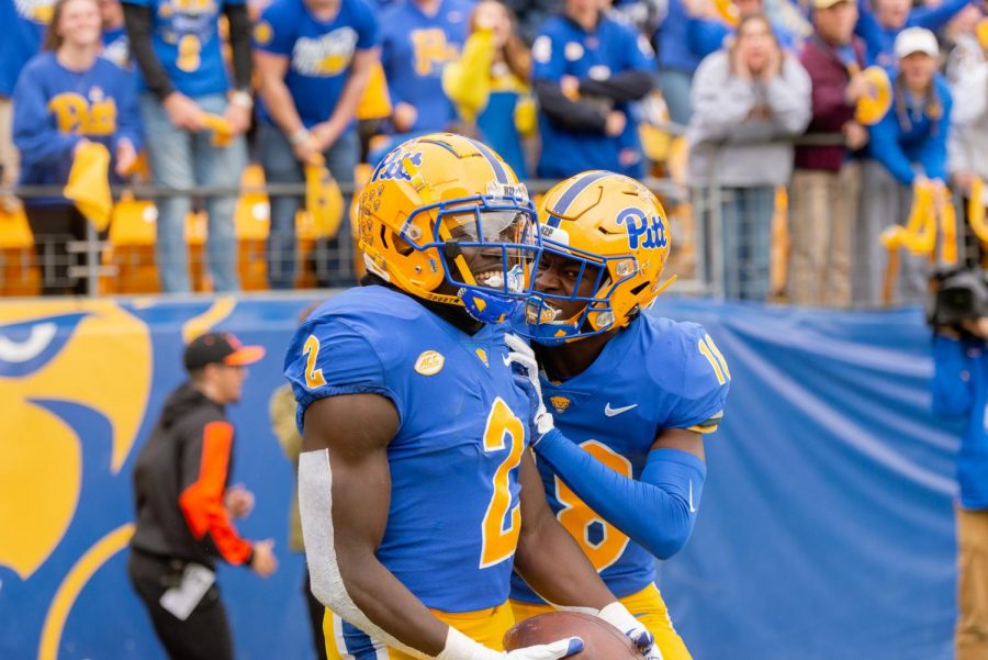Israel Abanikanda (2) and Calijah Kancey (8) celebrate a touchdown during Pitt football’s game vs. Miami on Oct. 30, 2021 at Acrisure Stadium.