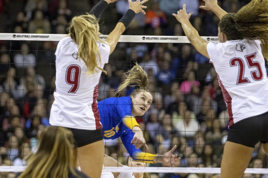 Pittsburghs Rachel Fairbanks (10) spikes the ball against Louisvilles Claire Chaussee (9) and Amaya Tillman (25) during the semifinals of the NCAA volleyball tournament, Thursday, Dec. 15, 2022 in Omaha, Neb. 