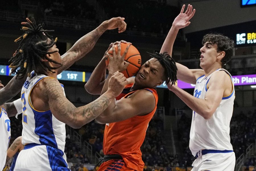 Clemson forward RJ Godfrey, center, cant get a shot off as Pittsburgh guard Nike Sibande (22) and Guillermo Diaz Graham (25) defend during the first half of an NCAA college basketball game in Pittsburgh, Saturday, Jan. 7, 2023. Clemson won 75-74. 