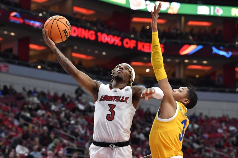 Louisville guard El Ellis (3) attempts a layup past Pittsburgh guard Greg Elliott (3) during the second half of a college basketball game in Louisville, Ky., on Wednesday, Jan. 18.