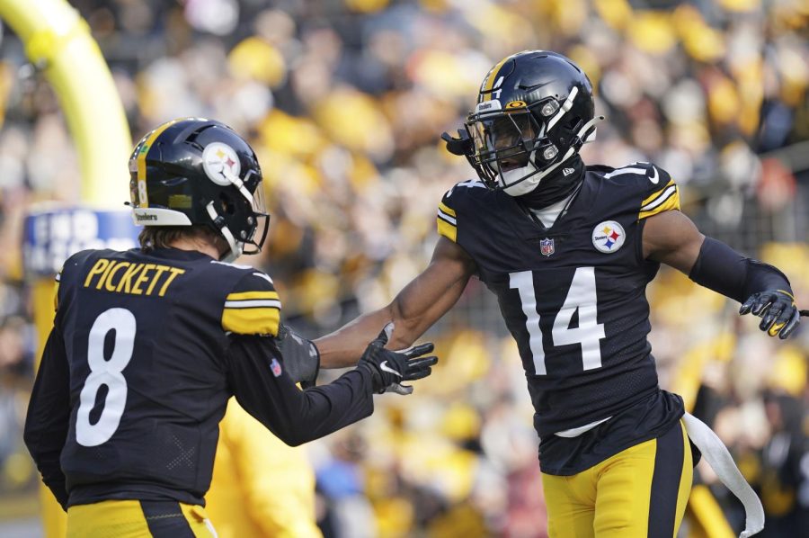 Pittsburgh Steelers wide receiver George Pickens (14) celebrates a touchdown with quarterback Kenny Pickett during the first half of an NFL football game against the Cleveland Browns in Pittsburgh, Sunday, Jan. 8, 2023. 
