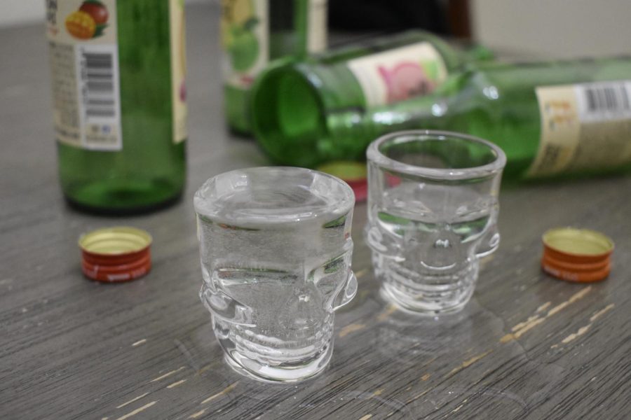 Two shot glasses sit on a table.