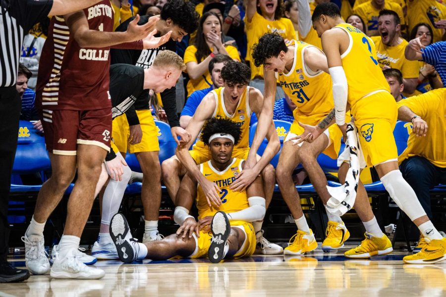 Junior forward Blake Hinson (2) sits on the ground after making a three-pointer against Boston College as the rest of the team celebrates.
