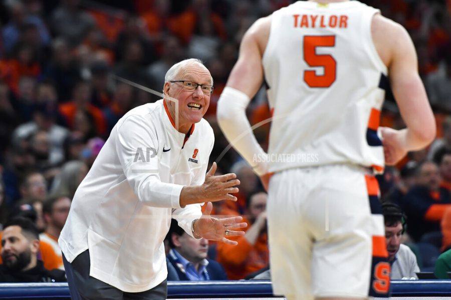 Syracuse head coach Jim Boeheim, left, gives instructions to guard Justin Taylor during the first half of an NCAA college basketball game against Virginia in Syracuse, N.Y., Monday, Jan. 30, 2023. (AP Photo/Adrian Kraus)