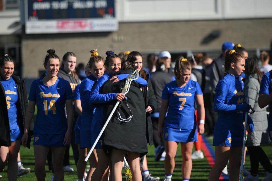 Pitt lacrosse players on the sidelines of their game against Duquesne on Feb. 11.