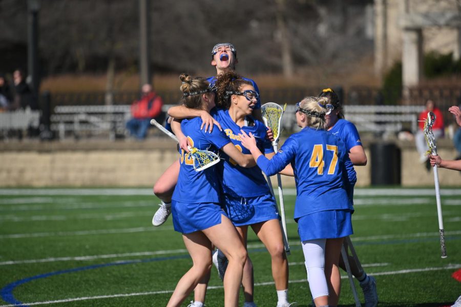 Pitt women’s lacrosse players celebrate a goal during Pitt’s opening season game at Duquesne on Saturday. 