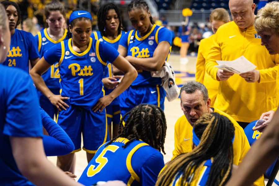 The Pitt women’s basketball team listens to coach Lance White on the sideline during the game against Syracuse on Thursday. 