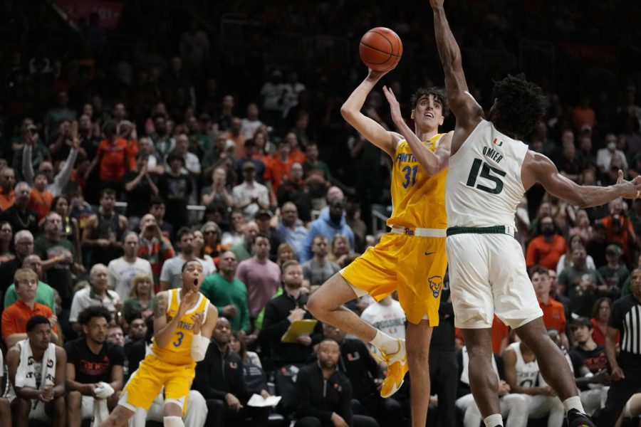 Pittsburgh forward Jorge Diaz Graham (31) shoots against Miami forward Norchad Omier (15) during the first half of an NCAA college basketball game Saturday, March 4, 2023, in Coral Gables, Fla. 