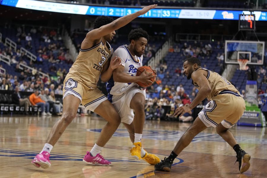 Pittsburgh guard Nelly Cummings drives between Georgia Tech guard Dallan Coleman and guard Kyle Sturdivant during the second half of an NCAA college basketball game at the Atlantic Coast Conference Tournament, Wednesday, March 8, 2023, in Greensboro, N.C. 