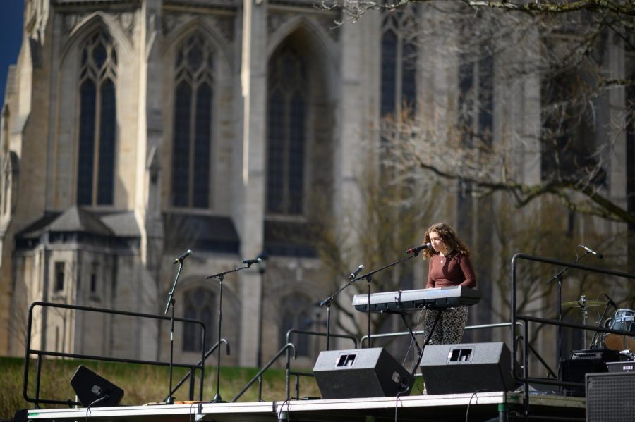 A band member sings and plays the piano during the Pitt Tonight Benefit Concert celebrating women’s empowerment month Saturday on the Cathedral of Learning lawn. 