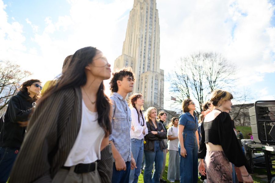 Spectators watch the Pitt Tonight Benefit Concert celebrating women’s empowerment month Saturday on the Cathedral of Learning lawn. 