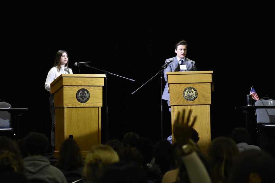 Two students from the College Democrats and College Republicans debate in the William Pitt Union Monday night.
