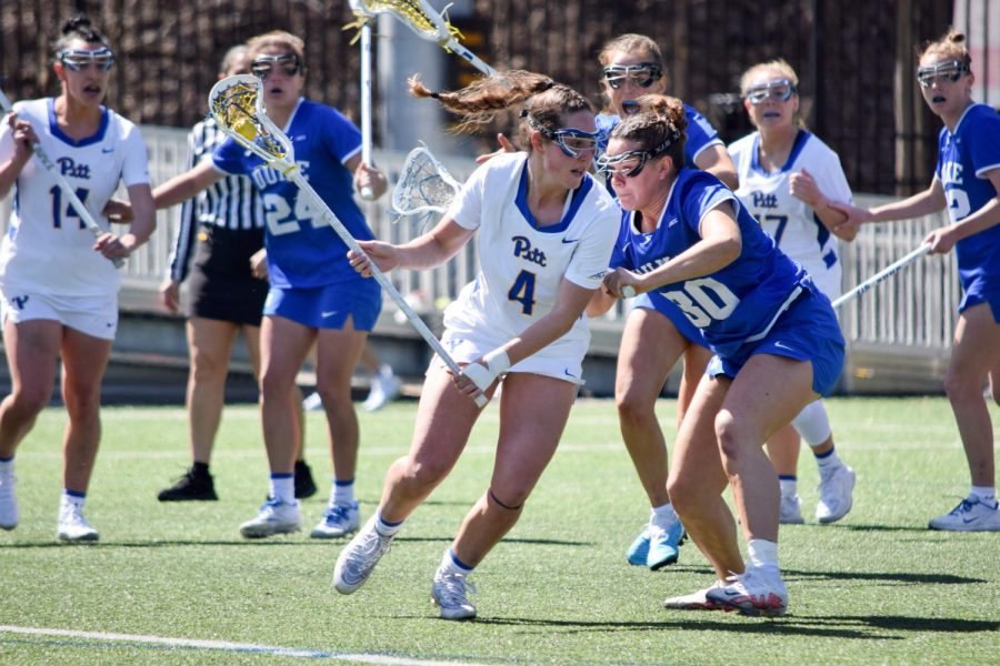Junior midfielder Emily Coughlin (4) runs with the ball during Pitt women’s lacrosse’s game against Duke at Highmark Stadium Sunday afternoon.