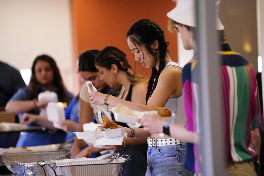 A student takes food during the “Oh We Belong End of Year Celebration” put on by Pitt’s Office of Inclusion and Belonging at the William Pitt Union on Friday. 