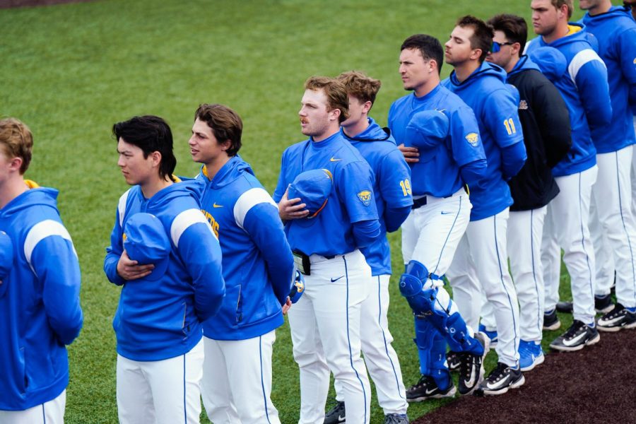 Pitt baseball players stand for the national anthem during a game against Notre Dame on Friday.