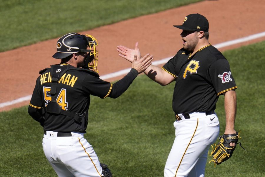 Pittsburgh Pirates relief pitcher David Bednar, right, celebrates with catcher Tyler Heineman after getting the final out of the ninth inning in a baseball game against the Chicago White Sox in Pittsburgh on April 9.