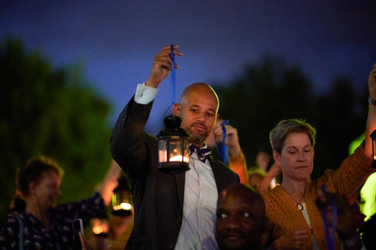 Clyde Wilson Pickett, the Vice Chancellor for Equity, Diversity, and Inclusion, holds up a lantern during the 103rd Lantern Night on the Cathedral lawn on Sunday evening.