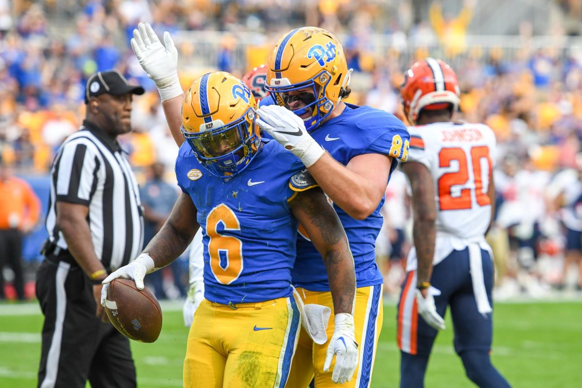 Sophomore running back Rodney Hammond Jr. (6) and another Pitt player celebrate at a game against Syracuse at Acrisure Stadium on Nov. 5, 2022