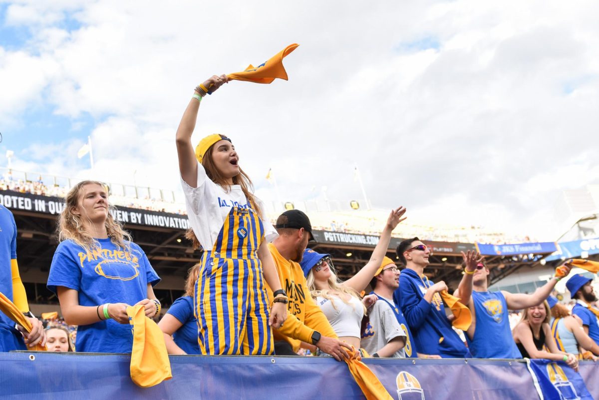 Pitt fans celebrate in the stands of Acrisure Stadium during the Backyard Brawl against WVU on Sept. 1, 2022.