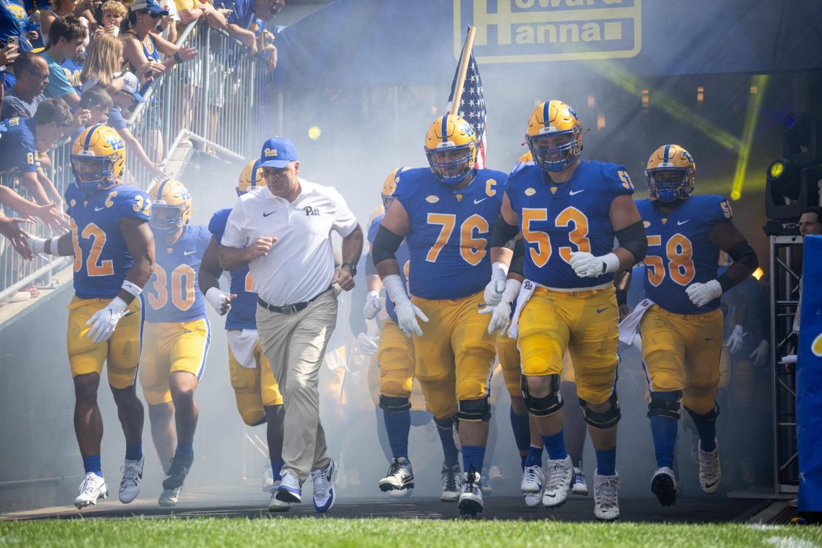 Pitts football team and head coach Pat Narduzzi run onto the field for the first game of the season against Wofford at Acrisure Stadium on Saturday afternoon. 