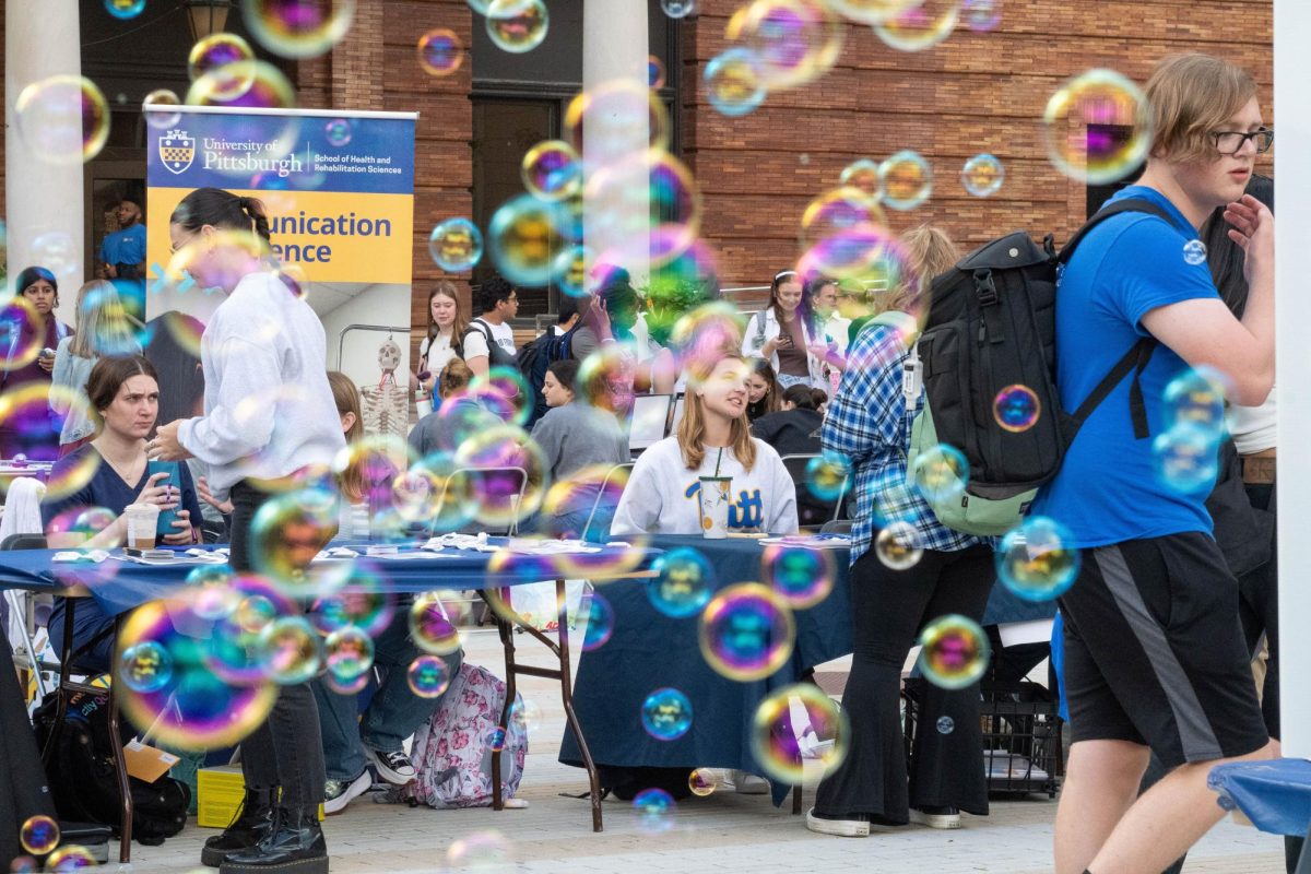Bubbles float through the Panther Wellness Fair booths in front of the William Pitt Union on Wednesday.