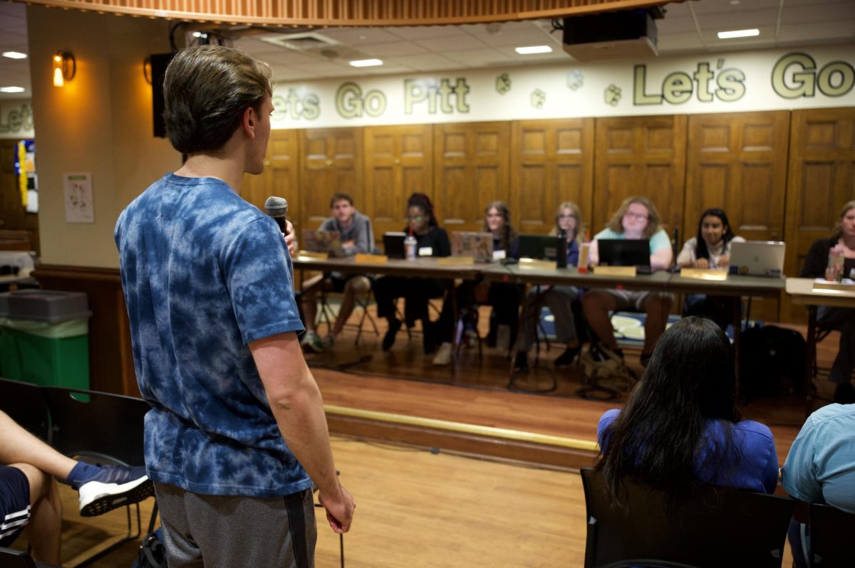 A member of Delta Sigma Pi speaks to the student government board during Tuesday night’s public meeting.