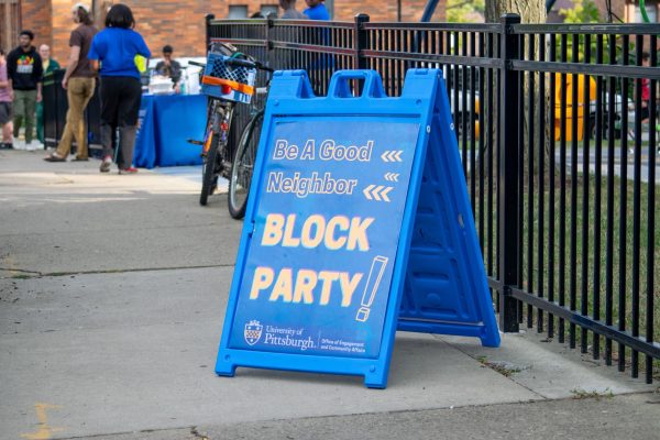 A sign welcomes residents to the Be A Good Neighbor Block Party on Tuesday.