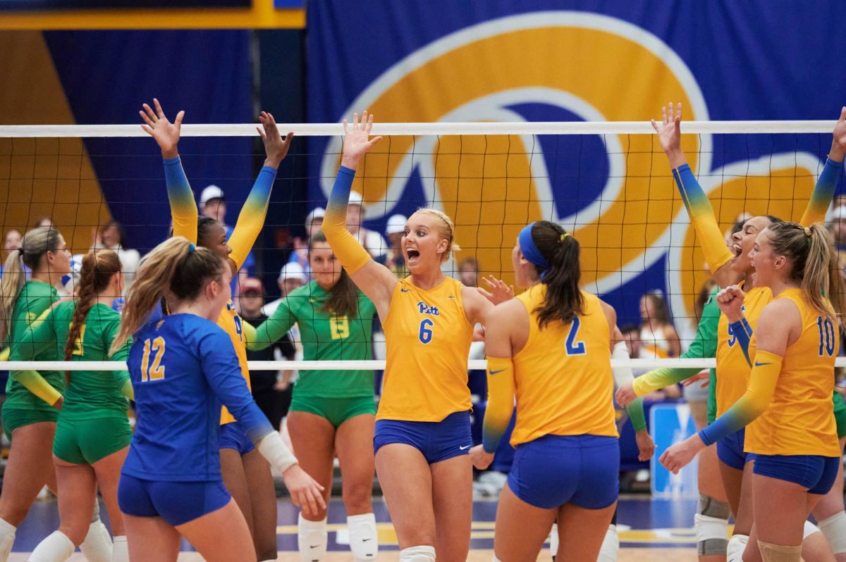 Pitts volleyball team celebrates a score against Oregon in the Fitzgerald Field House on Thursday night.