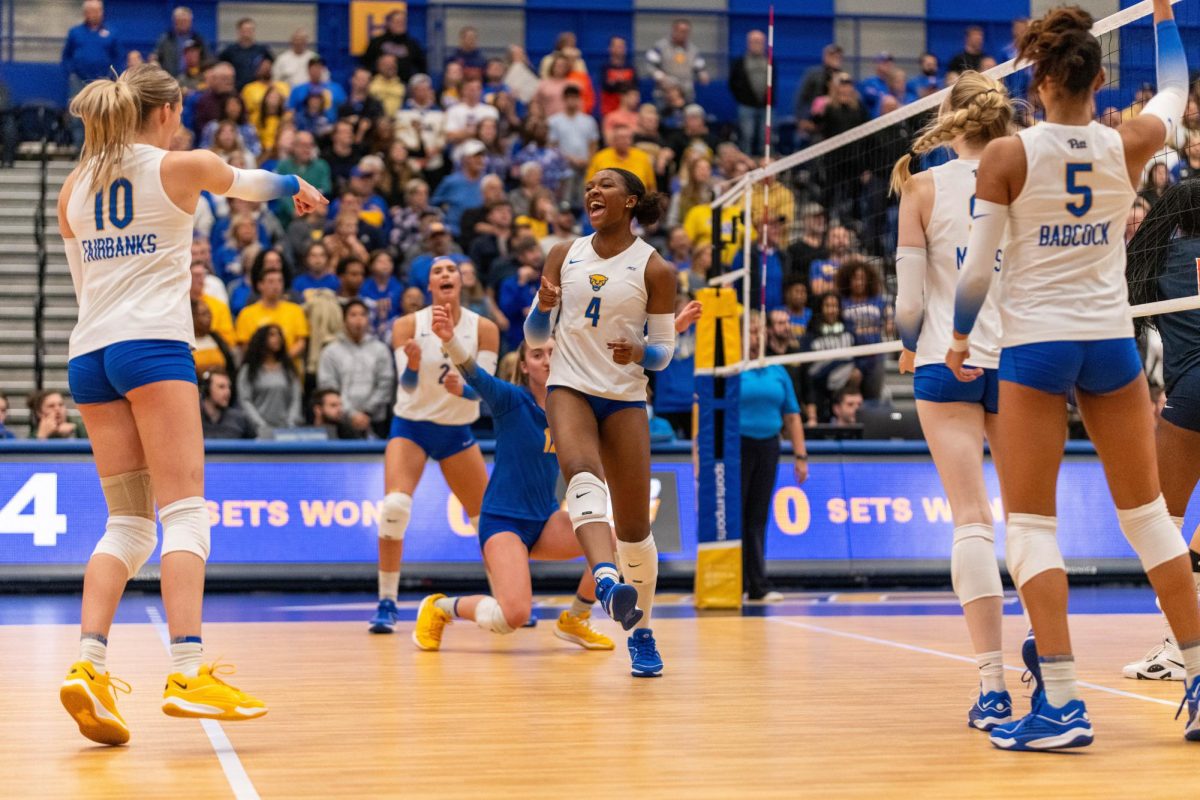 Pitt’s volleyball team celebrates a score during the game against Virginia at the Fitzgerald Field House on Wednesday night. 