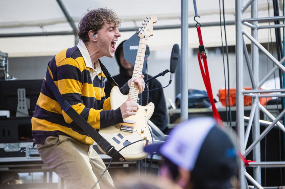 COIN’s lead vocalist Chase Lawrence shreds the guitar during Fall Fest at Schenley Drive on Sunday.