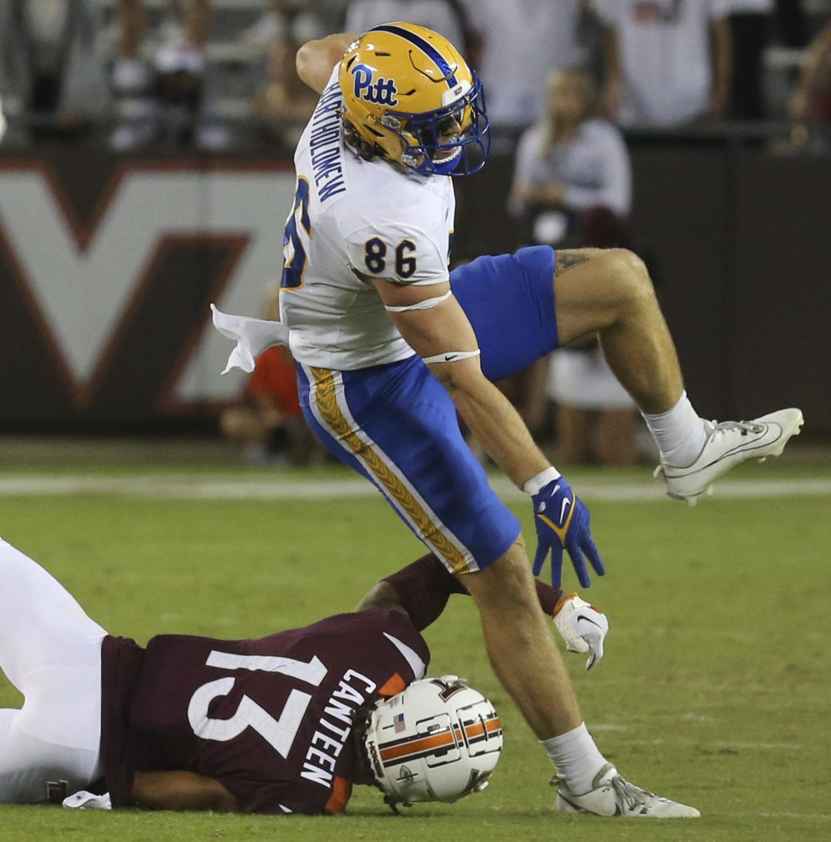 Pittsburghs Gavin Bartholomew (86) is tripped by Virginia Tech defender Derrick Canteen (13) during the second half of an NCAA college football game Saturday, Sept. 30, 2023, in Blacksburg, Va.
