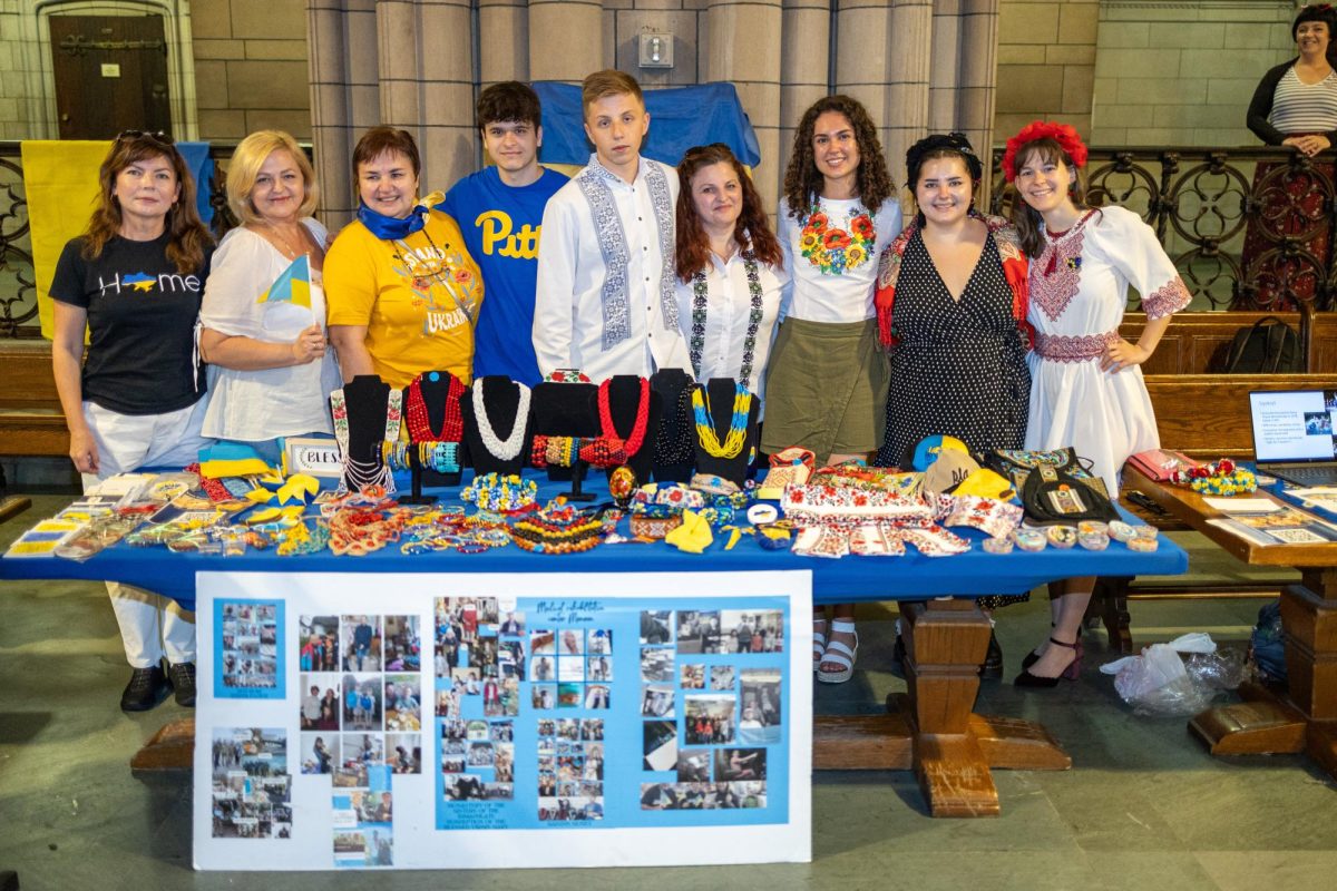 Festival presenters stand together behind the Ukrainian Heritage table during the Eastern European Festival on Sunday in the Cathedral of Learning. 