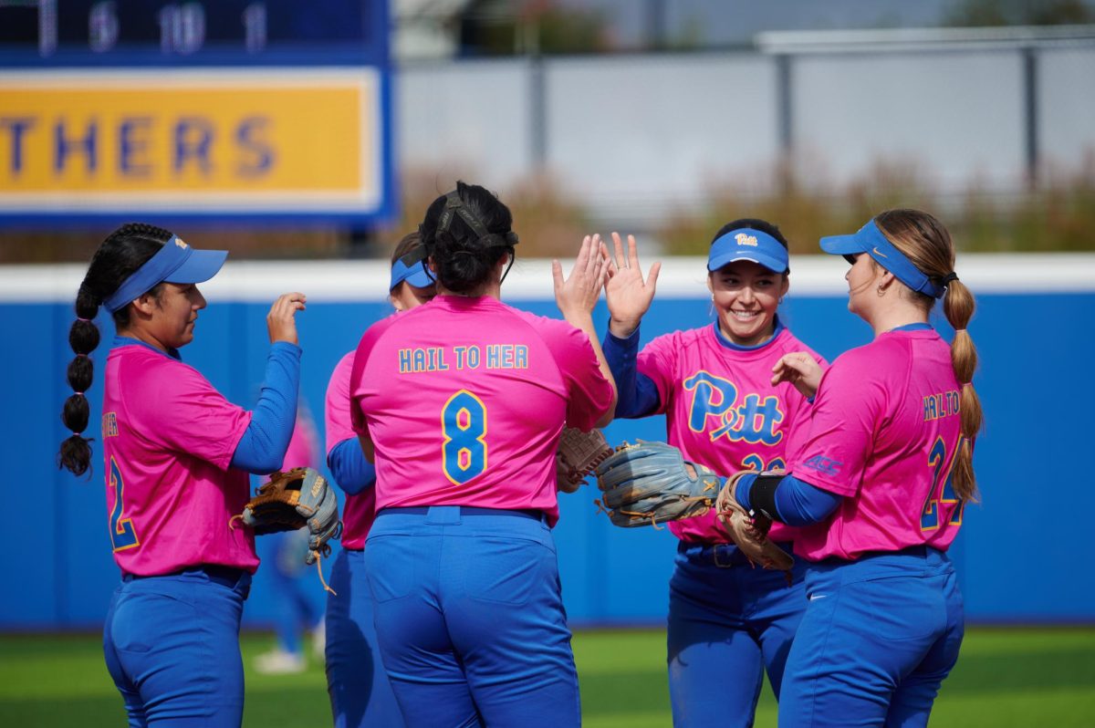 Pitt’s softball team celebrates a score during the game against Davis & Elkins on Sunday at Vartabedian Field.