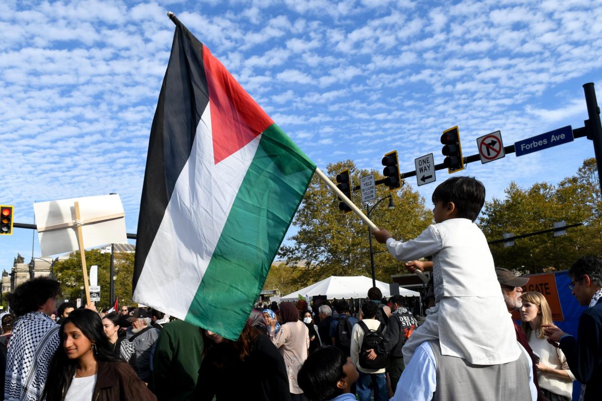 A child waves a Palestinian flag at a rally in support of Palestine in Oakland Friday afternoon. 