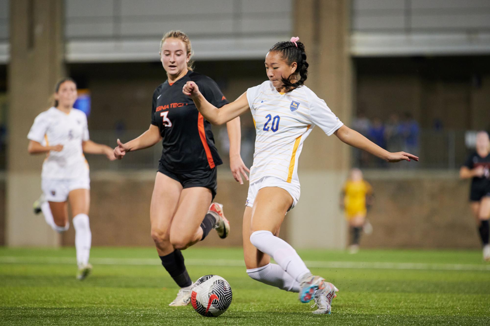 First-year defender Olivia Lee (20) defends the ball during the game against Virginia Tech at the Ambrose Urbanic Field on Thursday night.