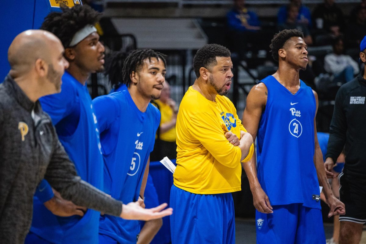 Head Coach Jeff Capel stands with players to watch a practice drill during an open practice at the Petersen Events Center on Friday, Oct. 13.