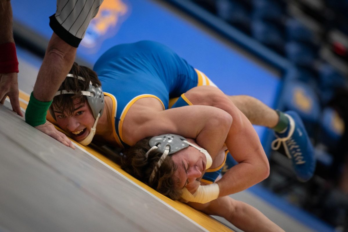 A Pitt wrestler attempts to pin their opponent during the Blue-Gold Dual at the Fitzgerald Field House on Monday evening. 