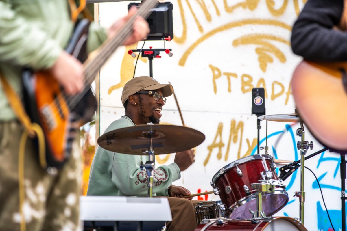 Brian, the drummer of local indie rock band Pitter Patter, performs at the Unplugged Oakland Fall Festival in Schenley Park on Saturday.