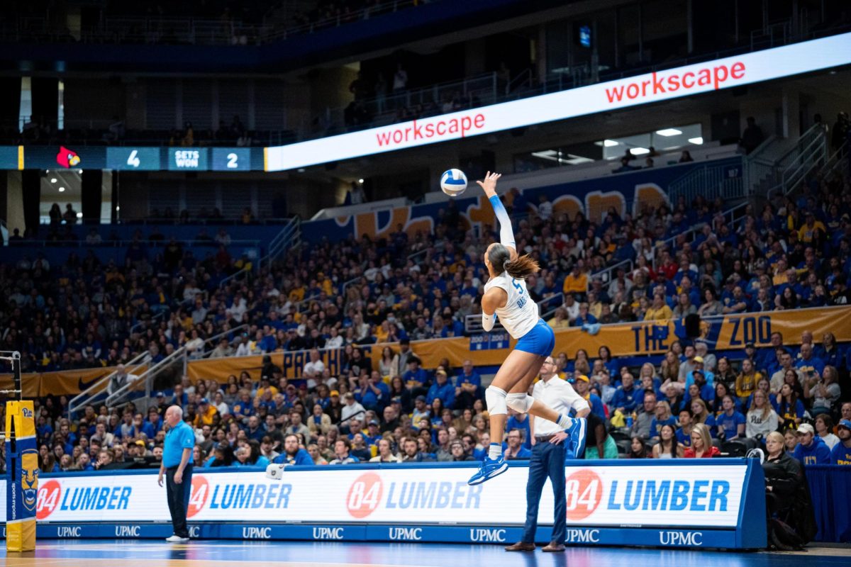 First-year opposite hitter Olivia Babcock (5) serves the ball in front of a record-setting crowd during Saturday afternoons match against Louisville at the Petersen Events Center.