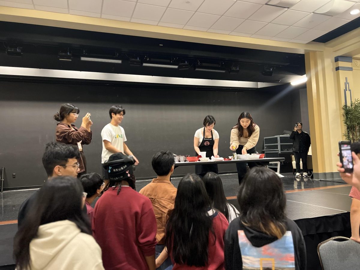 Christine Ha leads a cooking demonstration during an event organized by Pitt’s Asian Student Association.