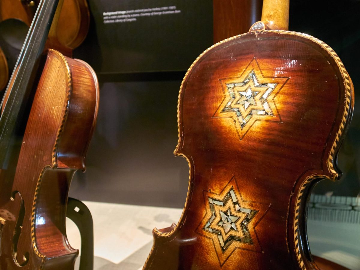 A+violin+is+displayed+with+a+Star+of+David+engraving+on+its+back+at+the+%E2%80%9CViolins+of+Hope%E2%80%9D+exhibit+in+the+Posner+Center+at+CMU.