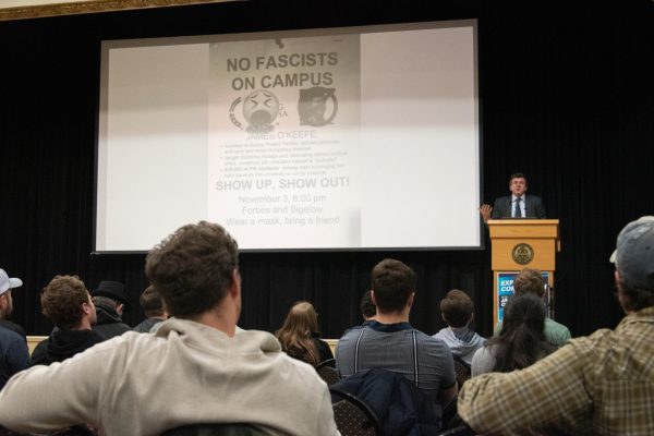 James O’Keefe projects a protest flyer during his event at the O’Hara Student Center on Thursday night.