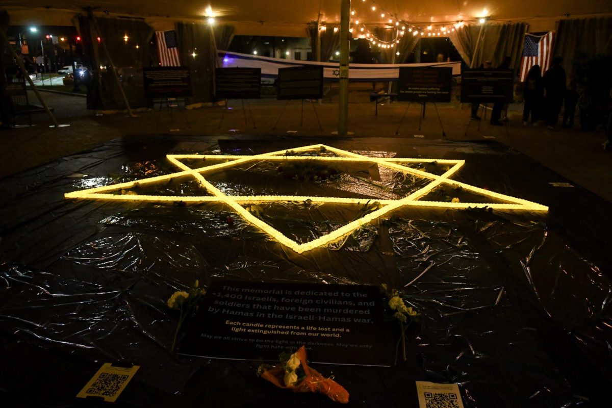 Candles arranged in the shape of the Star of David under the tent at Schenley Plaza on Friday.