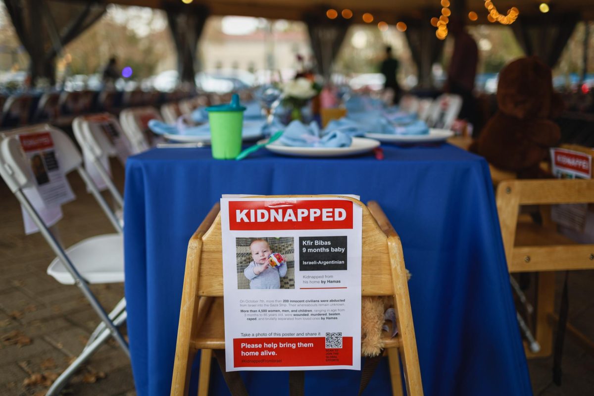 A “kidnapped” poster for a young baby sits at the head of a staged shabbat table in Schenley Plaza this weekend to raise awareness for the Israeli hostage crisis in Gaza. 