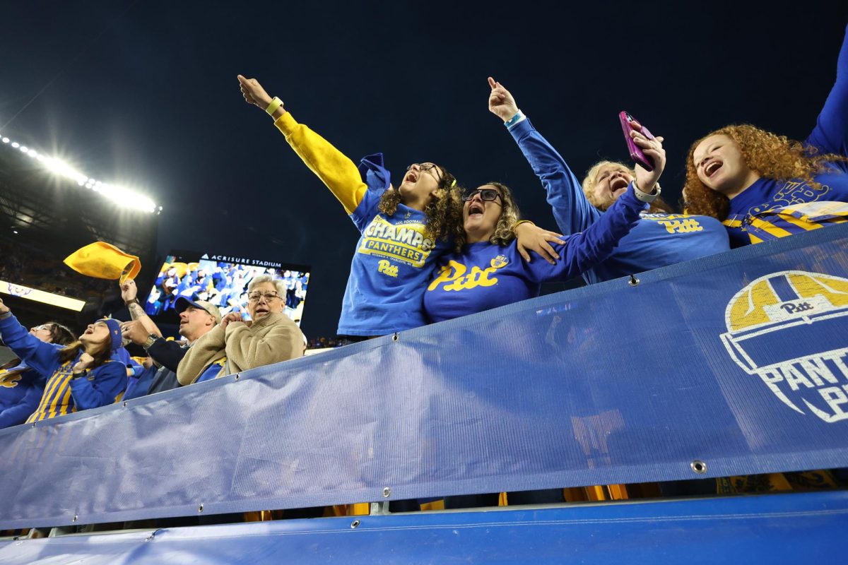 Pitt fans and their families sing Sweet Caroline during Saturday evenings game against FSU at Acrisure Stadium.