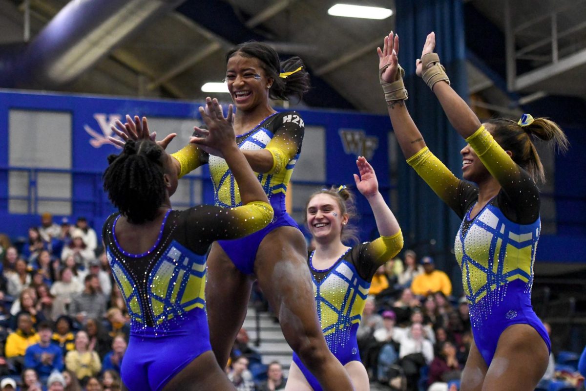 Pitt gymnasts celebrate during the NCAA regionals at the Petersen Events Center in April.