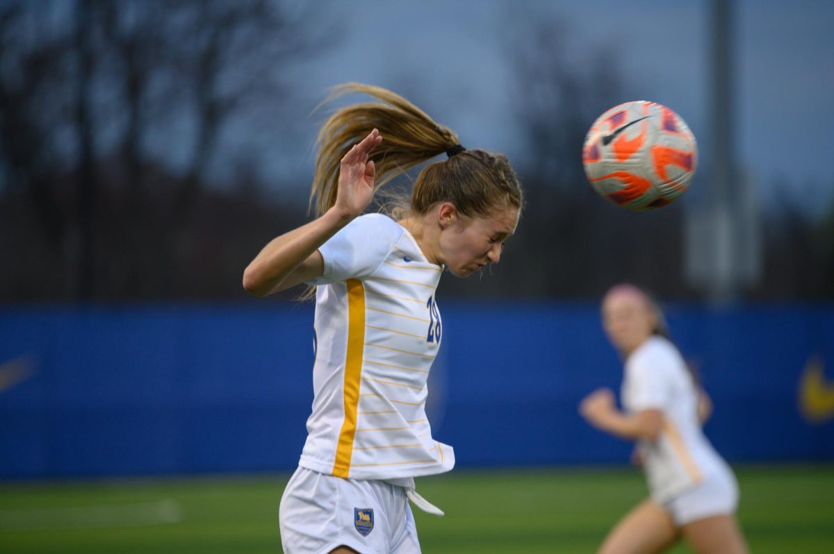 Junior Mackenzie Evers (11) heads the soccer ball during the spring game against West Virginia on Wednesday, April 5. 