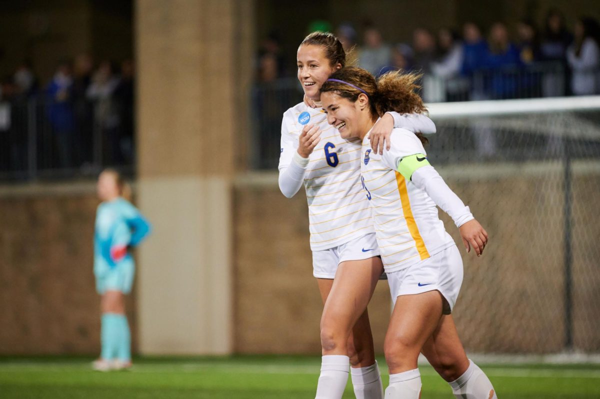 Fifth year midfielder Landy Mertz (6) and senior midfielder Chloe Minas (15) celebrate together during Saturday nights game against Ohio State in the first round of the NCAA tournament at the Petersen Sports Complex.