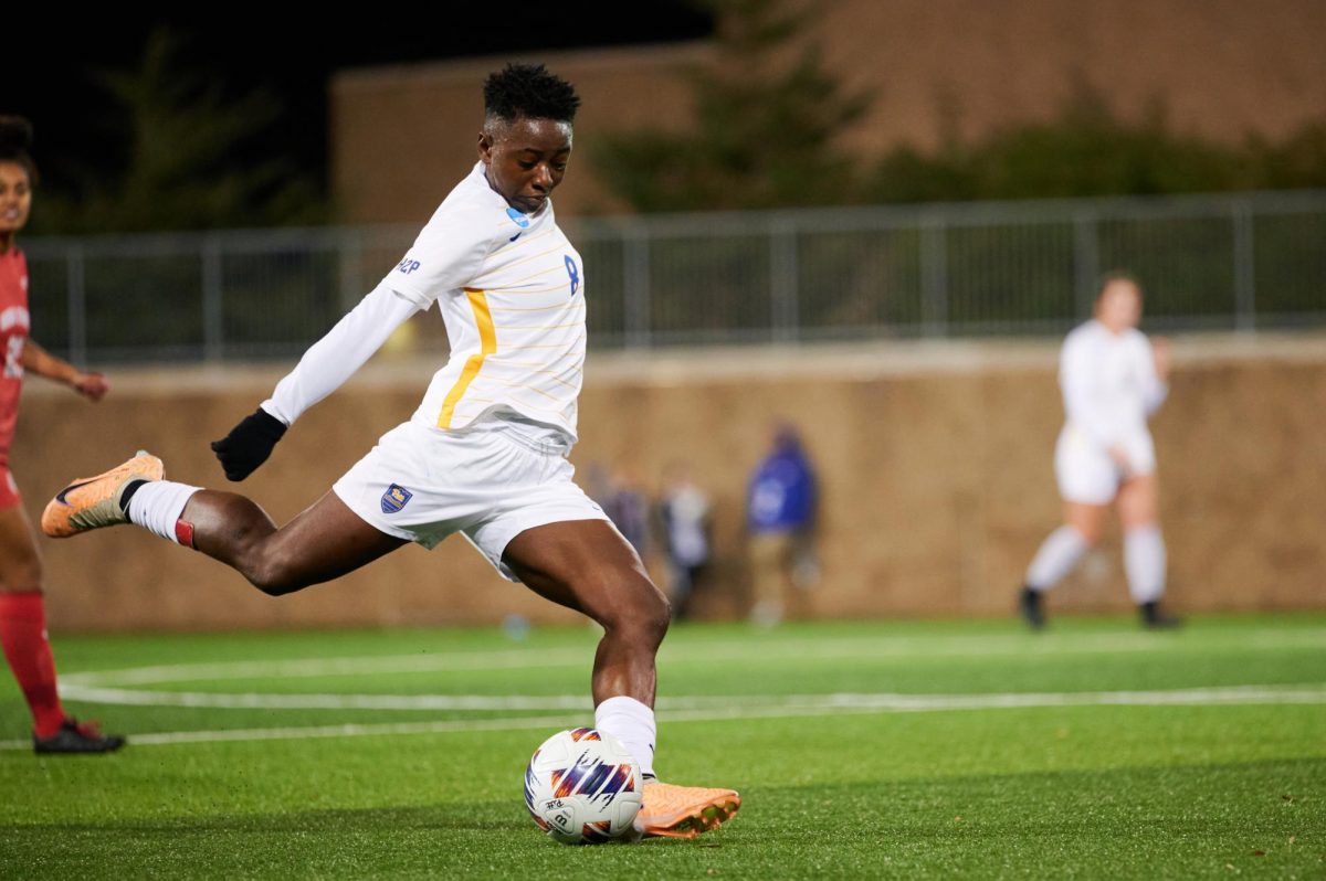 First year midfielder Deborah Abiodun (8) strikes the ball during Saturday nights game against Ohio State in the first round of the NCAA tournament at the Petersen Sports Complex.